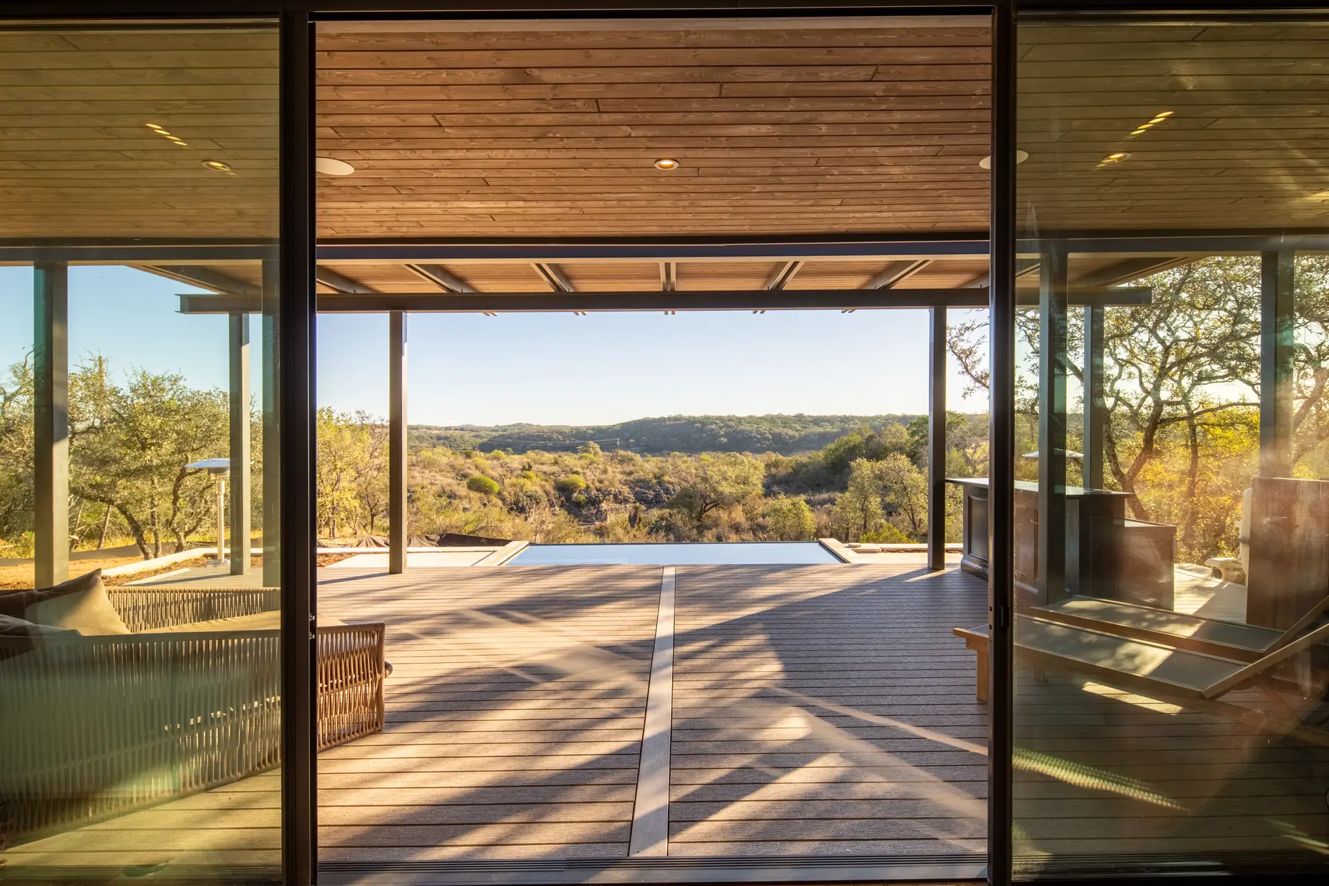 Aura's covered deck and pool looking over the Hill Country