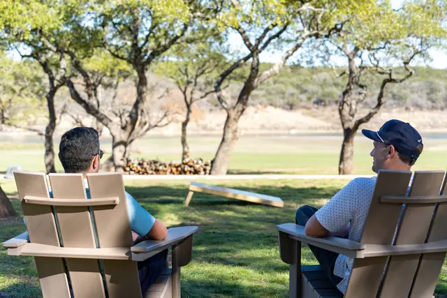 Two chairs under the oaks by the lake